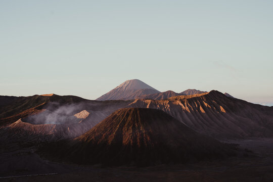 Majestic Volcanic Landscape Sunrise over Smoldering Peaks