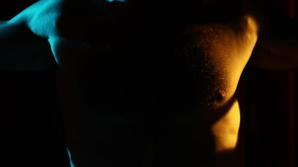 An athlete's hands grip a pull-up bar in a dark, moody gym. Cool, futuristic neon lighting creates dramatic silhouettes, perfect for strength training and workout motivation videos. - Powered by Adobe