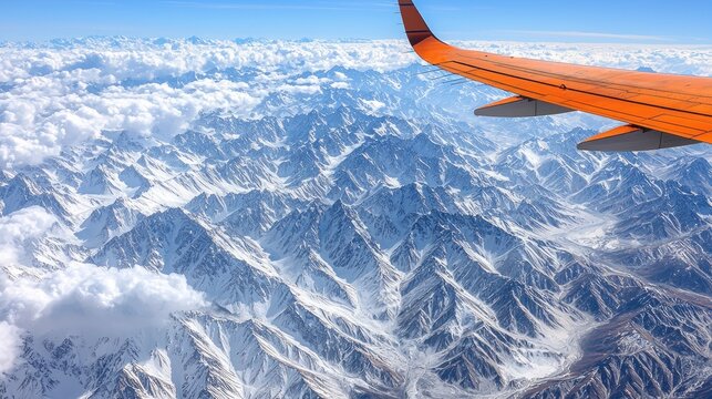 Aerial view of mountain range with orange wing