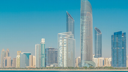 Fototapeta premium View of high skyscrapers on a corniche in Abu Dhabi stretching alongside the business center timelapse hyperlapse.