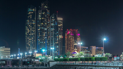Naklejka premium Skyscrapers of Abu Dhabi at night with Etihad Towers buildings timelapse.