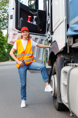 Portrait young adult happy smiling woman climbing cabin heavy truck driver cargo vehicle. Female person girl professional job career working driving freight engine lorry. Logistics industry