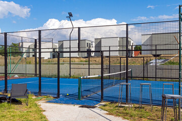 Empty padel tennis racket sport court outside in a city