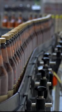  beer cans are moving along the conveyor beltTechnological line for bottling of beer in brewery. Empty aluminum beer cans are moving a