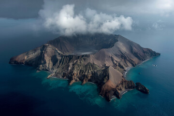 Aerial View of Muted Volcanic Island Surrounded by Blue Gray Ocean