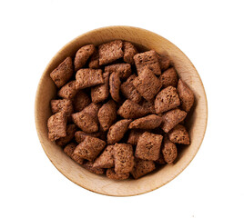 wooden bowl of tasty chocolate corn pads isolated on a white background, top view.