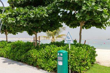 Dog-friendly beach in Dubai Islands with clean green lawn, pet waste station, and modern infrastructure. Peaceful place for pets and owners to relax by the sea