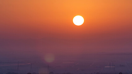 Obraz premium Beautiful sunrise in lonely desert and mountain in the background timelapse, Ajman, UAE