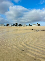 White sand and transparent ocean water on the coast of El Cotillo, peaceful summer evening in Fuerteventura, Canary Islands, Spain 