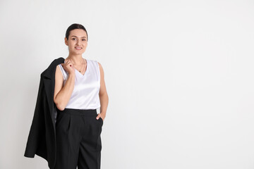 Confident business woman in suit on light background. Space for text