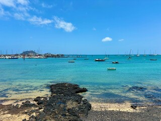 Turquoise ocean water of Corralejo harbor in Fuerteventura, Canary Islands, Spain, summer time, exotic vacations