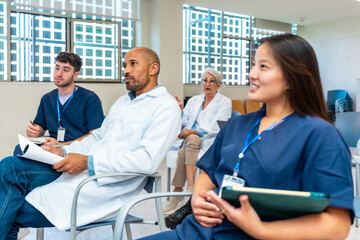 Medical team attending conference in hospital meeting room