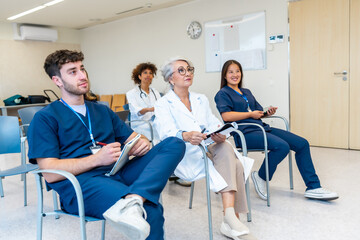 Medical team attending conference in hospital meeting room