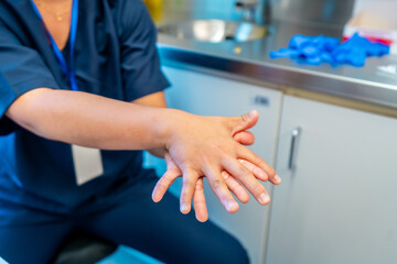 Doctor washing hands with soap and water in hospital or clinic