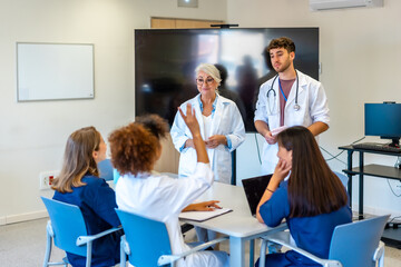 Medical team discussing patient cases during hospital meeting