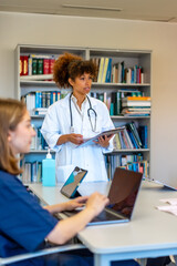 Medical team meeting discussing patient charts and reports in hospital conference room