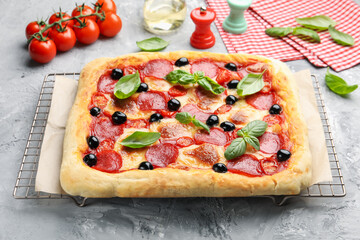 Tasty homemade pizza and ingredients on grey table, closeup