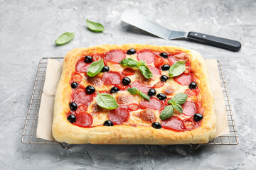 Tasty homemade pizza and server on grey table