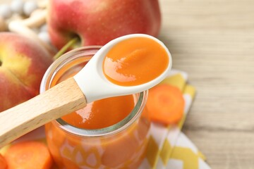Baby food. Tasty puree in jar, ingredients and spoon on table, closeup. Space for text