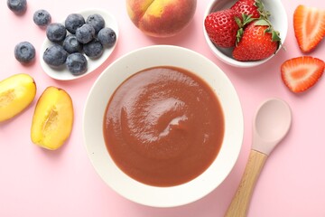 Baby food. Tasty puree in bowl and ingredients on pink background, flat lay