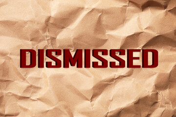 Word Dismissed on crumpled paper as background