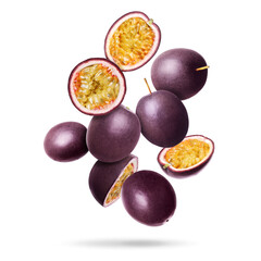 Delicious ripe passion fruits falling on white background