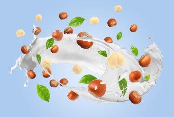 Nut milk splash with hazelnuts and green leaves in air on light blue background