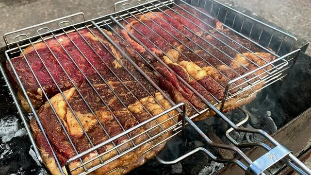 Grilled meat on the grill. Beef steaks are grilled on the grill.