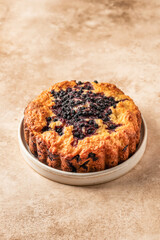 Blueberry cake on a plate on beige background isolated