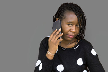 Isolated African Woman Talking on Smartphone Against Gray Background