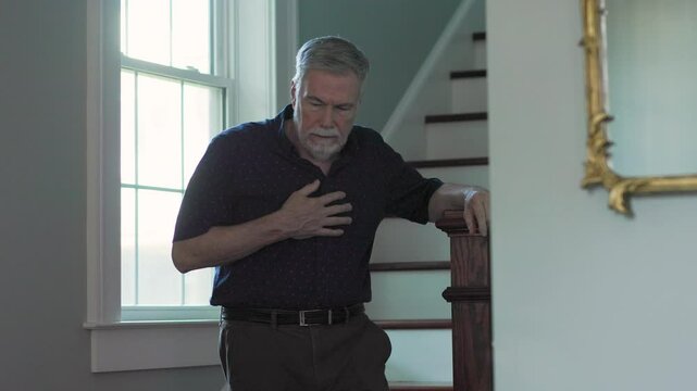senior man walking downstairs fears a heart attack