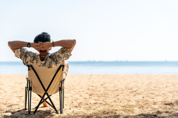 Happy Asian man travel nature the sea on summer beach holiday vacation. Handsome guy in beach...