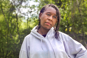 Active African Woman in Hoodie Outdoors in Sunlit Park