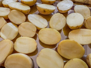 Small, Halved, Yellow Potatoes Uncooked On A Metal Sheet Pan