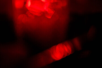 Abstract red lens flare effect on black background for design. Random color and light shapes.