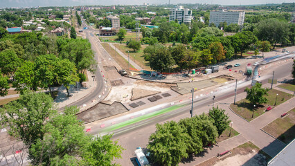 Road construction site with tram tracks repair and maintenance aerial timelapse.