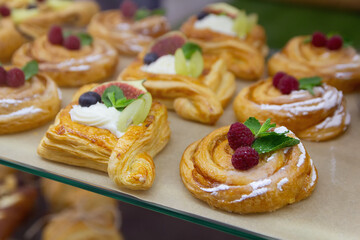 Delicious baking with berries and custard cream in glass showcase
