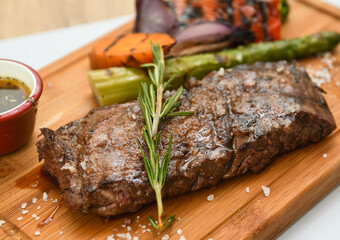 grilled beef steak with vegetable on wood board 