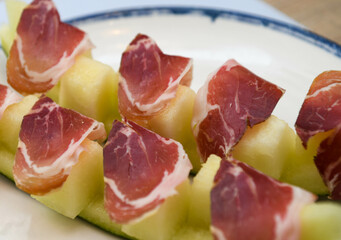 Slices of melon with prosciutto on a plate