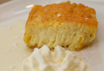 Cottage cheesecake served on a plate with whipped cream