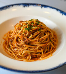 spaghetti bolognese with tomato sauce on a white plate