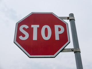 stop sign over cloudy sky