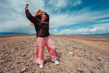 Young woman enjoy freedom in the mountains on summer day