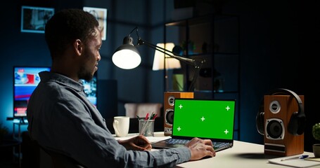 Self employed person checking financial graphs on chroma key screen, researching and sharing...