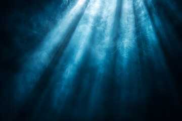 Fototapeta premium Diagonal light beams illuminating a dark background create a striking contrast, evoking feelings of hope, faith, and spirituality while enhancing the overall atmosphere of mystery
