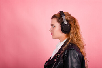 Woman with headphones, listening to music, fashion model in studio posing, music genre, smiling, rock, metal music
