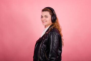 Woman with headphones, listening to music, fashion model in studio posing, music genre, smiling,...