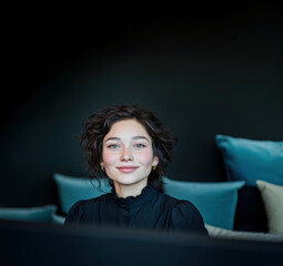 Office reception, receptionist photo. A young woman in a shirt in a professional modern office environment,  in conversation. Dark background with space for a logo. Modern teams, sophisticated style