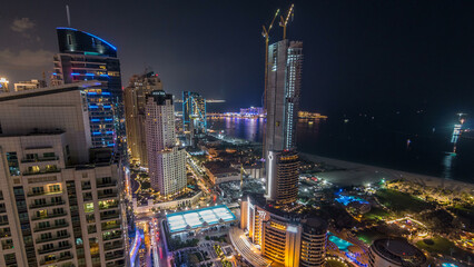 Naklejka premium Aerial view of modern skyscrapers and beach at Jumeirah Beach Residence JBR night timelapse in Dubai, UAE