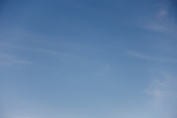 Clear blue sky and white cloud background.